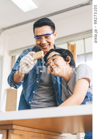 Southeast asian family father and son diy or repair for crafts skill at home workshop 98273105