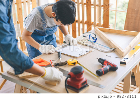 Southeast asian family father and son diy or repair for crafts skill at home workshop Southeast asian family father and son diy or repair for crafts skill at home workshop 98273111