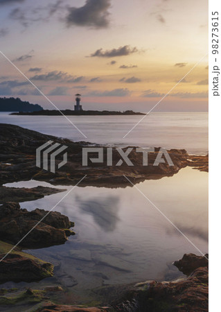 reflection of water on the rocks on the beach, lighthouse on the coast evening sunset kaolak phuket thailand 98273615
