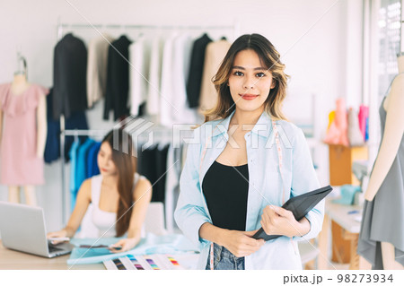 Portrait of young adult beautiful smile asian woman working tailor or fashion designer Portrait of young adult beautiful smile asian woman working tailor or fashion designer 98273934