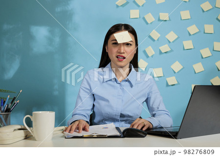 Female startup worker with a confused expression trying to understand the financial reports generated on software of laptop computer. Office employee working late to meet deadline. Female startup worker with a confused expression trying to understand the financial reports generated on software of laptop computer. Office employee working late to meet deadline. 98276809