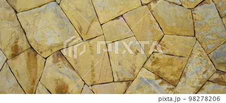 Sturdy yellow and beige cut stone wall, seamless lined up 98278206
