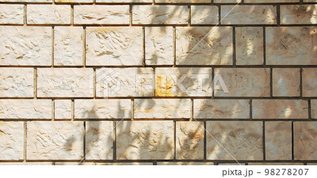 Sturdy yellow and beige cut stone wall, seamless lined up 98278207