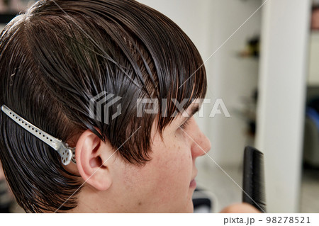 Professional barber during work with man client Professional barber during work with man client 98278521