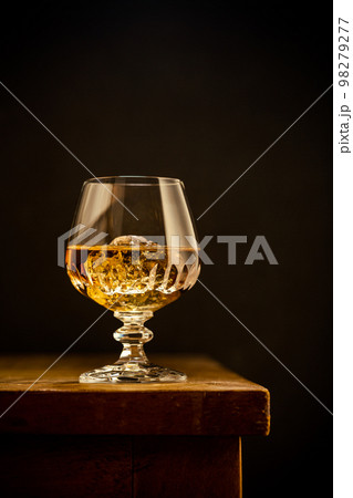 Glass of scotch whiskey and ice 98279277
