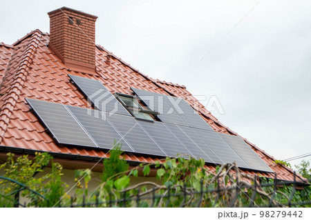 House roof with photovoltaic modules. Historic farm house with modern solar panels on roof and wall High quality photo House roof with photovoltaic modules. Historic farm house with modern solar panels on roof and wall High quality photo 98279442
