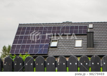 House roof with photovoltaic modules. Historic farm house with modern solar panels on roof and wall High quality photo 98279469