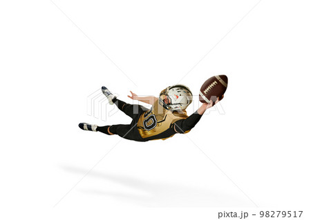 Catching ball in a jump. Man, american football player in motion, training over white studio background. Concept of sport, competition Catching ball in a jump. Man, american football player in motion, training over white studio background. Concept of sport, competition 98279517
