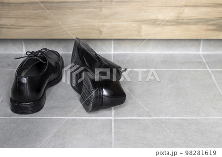 玄関で雑に脱いだビジネスシューズ 玄関で雑に脱いだビジネスシューズ 98281619