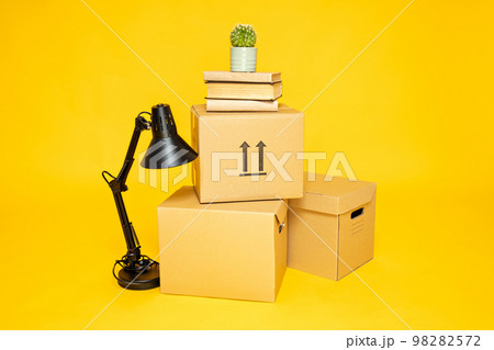 Concept of move with boxes on yellow background Concept of move with boxes on yellow background 98282572