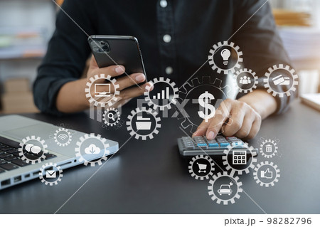 Investors have to calculate investment cost calculator and hold a mobile phone in hand. 98282796