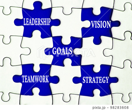 Business concept. Leadership, vision, goals, teamwork, and strategy text on missing jigsaw puzzle. Business concept. Leadership, vision, goals, teamwork, and strategy text on missing jigsaw puzzle. 98283608