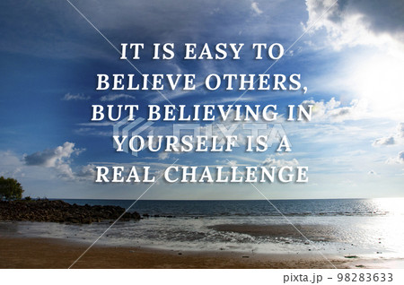 Motivational quotes text - It is easy to believe others, but believing in yourself is a real challenge. With beautiful beach background. Motivational concept. 98283633