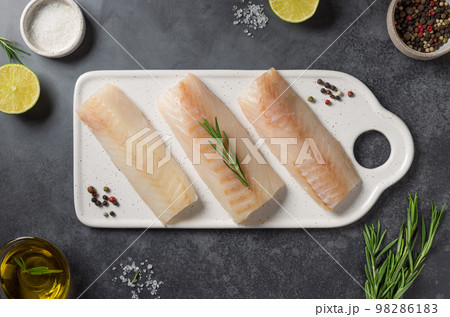 Fresh raw cod fish with ingredients for cooking Fresh raw cod fish with ingredients for cooking 98286183