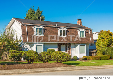 Big residential house on the street on sunny autumn day 98287478