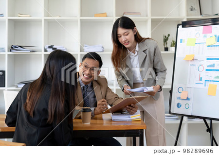A group of business people are meeting to analyze data for marketing plan A group of business people are meeting to analyze data for marketing plan 98289696