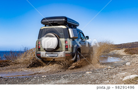 Off road tourist car rides off-road in the highlands. Expedition travel and vacation, adventures in remote areas. Off road tourist car rides off-road in the highlands. Expedition travel and vacation, adventures in remote areas. 98291496