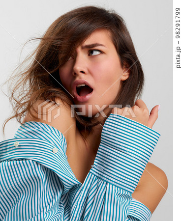 Closeup beauty fashion portrait of young sensual beautiful woman wearing male shirt posing on gray background. Female natural beauty, art, emotions concept 98291799