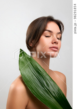 Portrait of beautiful happy young woman with smooth clear skin isolated over light studio background. Concept of natural beauty, skincare, cosmetology, health Portrait of beautiful happy young woman with smooth clear skin isolated over light studio background. Concept of natural beauty, skincare, cosmetology, health 98291854