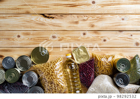 Donations food with canned food on the table background. Donate concept. Donations food with canned food on the table background. Donate concept. 98292532
