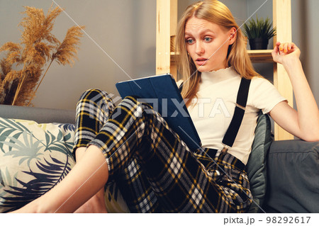 Woman at night home surfing on internet with digital tablet. Stay at Home. Woman at night home surfing on internet with digital tablet. Stay at Home. 98292617