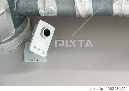 CCTV camera on gray wall close up 98293192