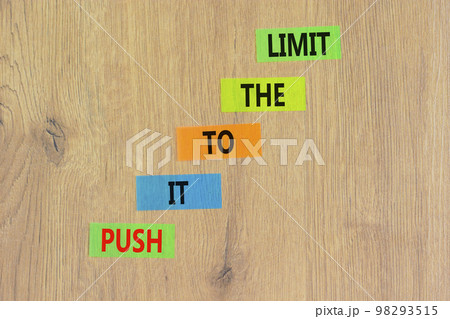 Push it to the limit symbol. Concept words Push it to the limit on colored paper. Beautiful wooden table wooden background. Business push it to the limit concept. Copy space. 98293515