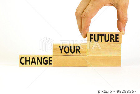 Change your future symbol. Concept words Change your future on wooden blocks on a beautiful white table white background. Businessman hand. Business, finacial and change your future concept. Copy 98293567