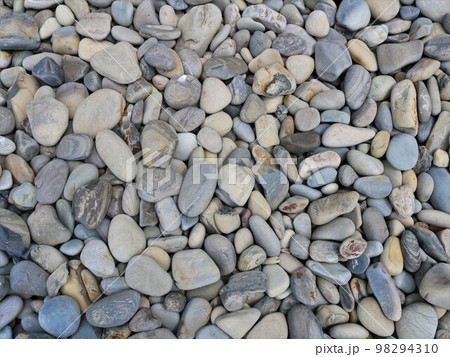 graphic resource of rounded sea stones in gray and brown shades with a beautiful texture full frame, building mineral material of round river cobblestones scattered on a flat surface 98294310