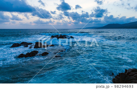Dramatic coastal landscape with waves and rocks in the evening Dramatic coastal landscape with waves and rocks in the evening 98294693