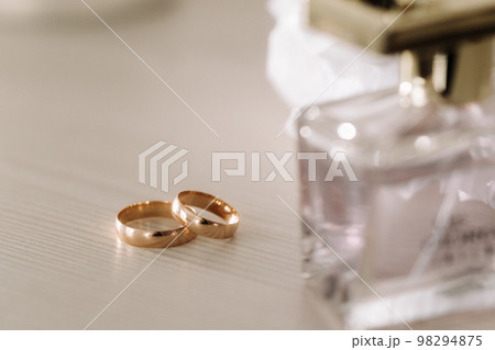 Designer wedding rings lying on the surface. Two wedding rings Designer wedding rings lying on the surface. Two wedding rings 98294875