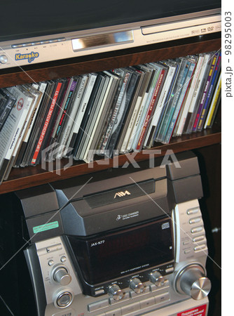 Old music center with cassettes and CDs from 90s. Compact disks and audio tapes Old music center with cassettes and CDs from 90s. Compact disks and audio tapes 98295003