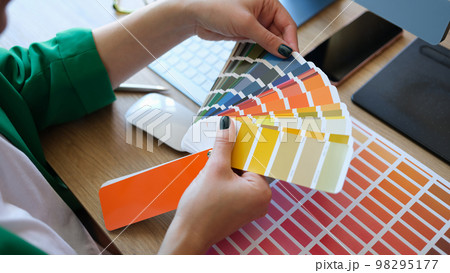Designer choosing colors for his future project in art studio. Designer choosing colors for his future project in art studio. 98295177