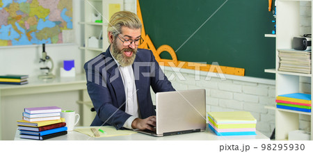 Concentrated on studying. private teaching at home. bearded man teacher. E-Learning concept. tutor work on modern laptop. back to school. student in classroom. Teachers day. online education course 98295930