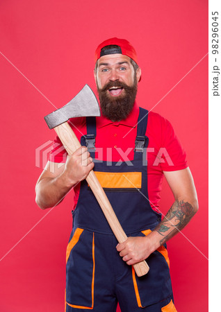 Brave worker. Cutting beard. Brutality and masculinity. Bearded lumberjack. Man builder uniform hold axe. Bearded man hold ax red background. Danger concept. Renovation concept. Bearded handyman 98296045