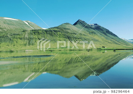 Blue sky - Green mountain - Clear Lake in Iceland - Scandinavian Landscape Sky and mountain reflect in the lake Blue sky - Green mountain - Clear Lake in Iceland - Scandinavian Landscape Sky and mountain reflect in the lake 98296464