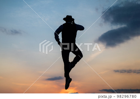 speaking on phone. man silhouette jump on sky background. confident businessman jumping. daily motivation. enjoying life and nature. business connection. freedom. Gear up to work mor 98296780