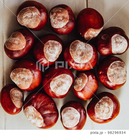 Ripe chestnuts on old wooden table and sack napkin close up with copy space. Raw Chestnuts for Christmas Ripe chestnuts on old wooden table and sack napkin close up with copy space. Raw Chestnuts for Christmas 98296934