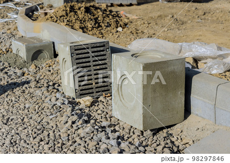Road works construction on well concrete base during laying installation of stormwater drainage Road works construction on well concrete base during laying installation of stormwater drainage 98297846