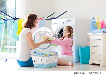 Family in laundry room with washing machine 98298019