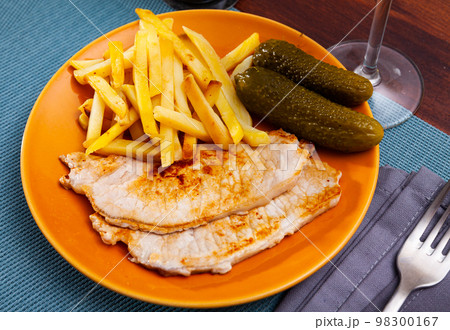 Juicy pork tenderloin with potatoes and salted cucumbers Juicy pork tenderloin with potatoes and salted cucumbers 98300167
