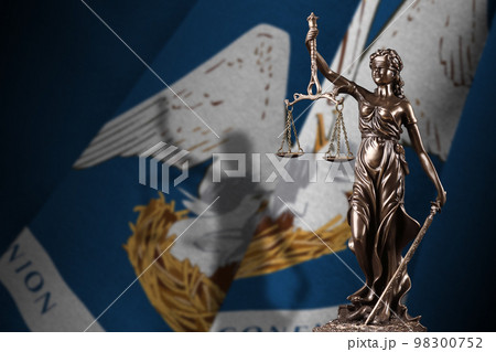 Louisiana US state flag with statue of lady justice and judicial scales in dark room. Concept of judgement and punishment 98300752