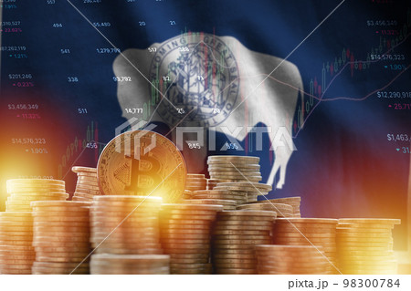 Wyoming US state flag and big amount of golden bitcoin coins and trading platform chart. Crypto currency Wyoming US state flag and big amount of golden bitcoin coins and trading platform chart. Crypto currency 98300784