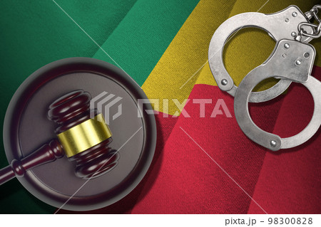 Benin flag with judge mallet and handcuffs in dark room. Concept of criminal and punishment, background for judgement topics 98300828
