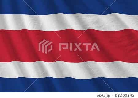Costa Rica flag with big folds waving close up under the studio light indoors. The official symbols and colors in banner 98300845