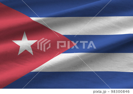 Cuba flag with big folds waving close up under the studio light indoors. The official symbols and colors in banner 98300846