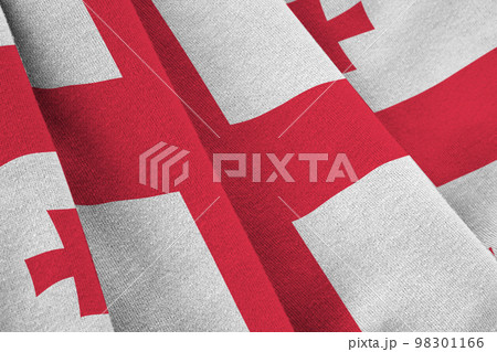 Georgia flag with big folds waving close up under the studio light indoors. The official symbols and colors in banner Georgia flag with big folds waving close up under the studio light indoors. The official symbols and colors in banner 98301166