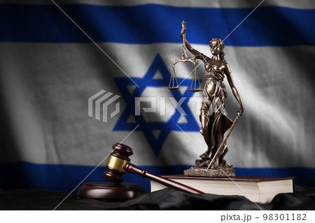 Israel flag with statue of lady justice, constitution and judge hammer on black drapery. Concept of judgement and guilt Israel flag with statue of lady justice, constitution and judge hammer on black drapery. Concept of judgement and guilt 98301182