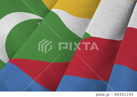 Comoros flag with big folds waving close up under the studio light indoors. The official symbols and colors in banner 98301195
