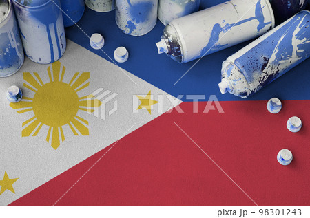 Philippines flag and few used aerosol spray cans for graffiti painting. Street art culture concept Philippines flag and few used aerosol spray cans for graffiti painting. Street art culture concept 98301243